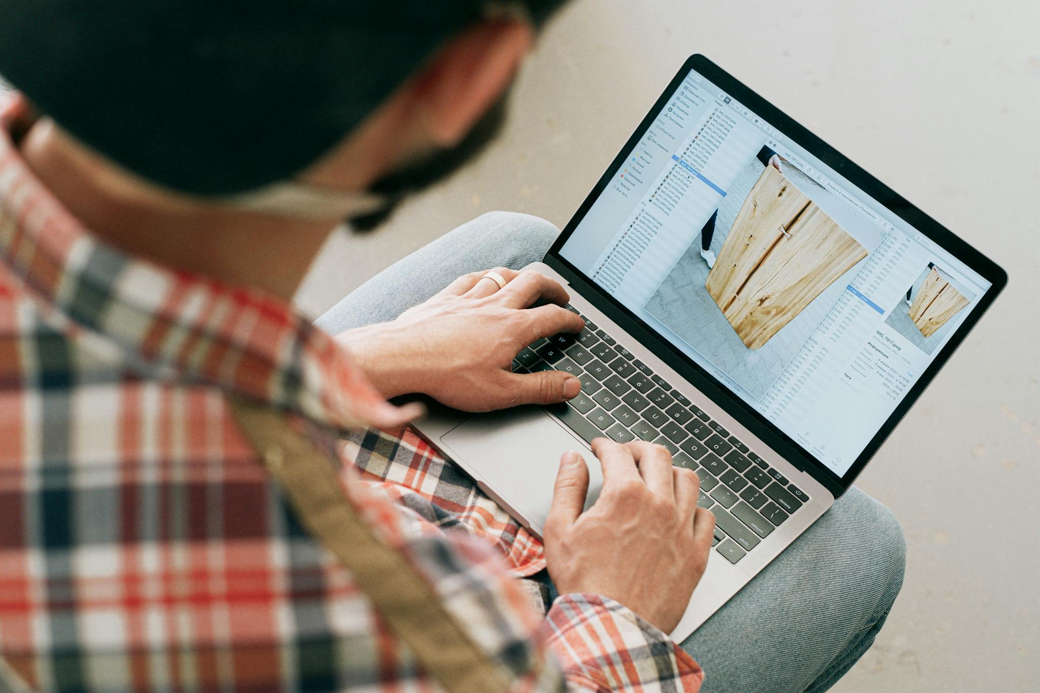 Person Using Macbook Air on Lap